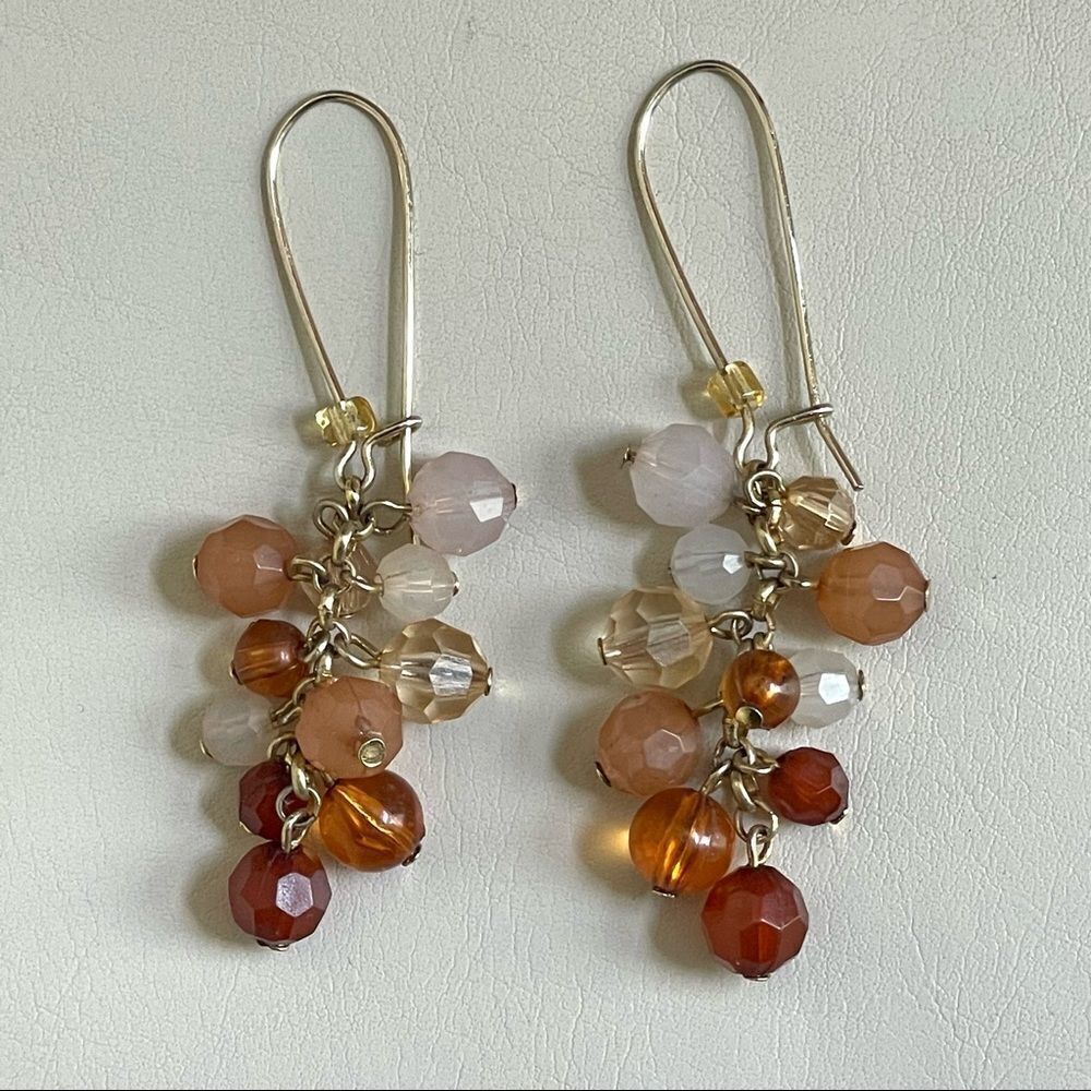 Gold tone orange beaded earrings